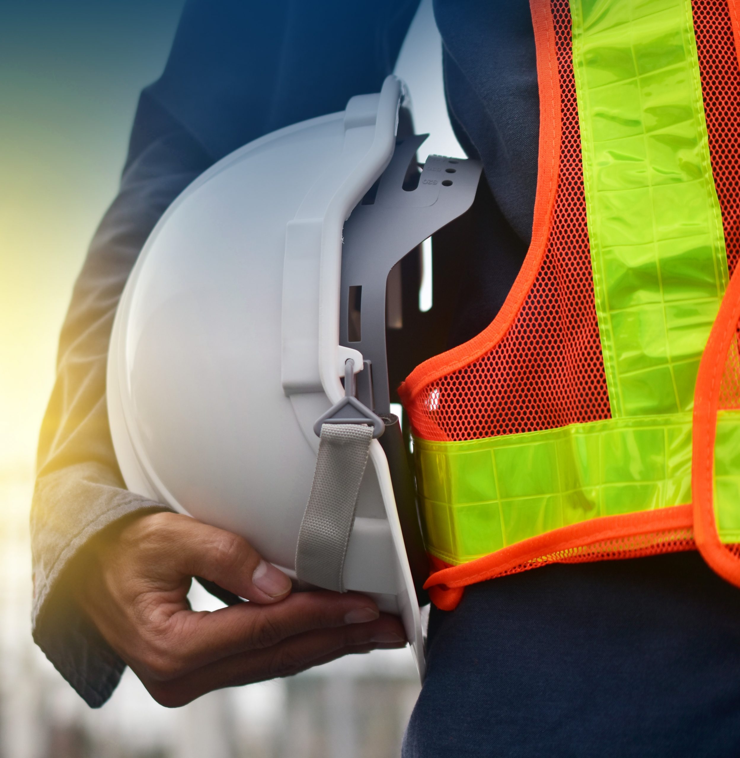 Technician holding white hat safety hard hat sunlight background